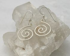 "These solid sterling silver earrings are designed from a simple spiral shape. These spiral earrings are nice & lightweight making them comfortable for everyday wear. The earrings hang 1.5\" from the top of the ear-wire to the bottom of the hoop Currently in Stock & Ready to Ship Ear-wires are handmade of high quality Argentium sterling silver, so even people who have allergic reactions to the copper in standard sterling silver can comfortably wear these. Other sale items listed here: ht Silver Wire Earrings, Rectangular Earrings, Long Silver Earrings, Dangle Earrings Silver, Swirl Earrings, Spiral Earrings, Message Jewelry, Etsy Earrings Dangle, Fine Jewellery Earrings