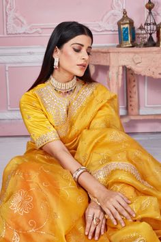 Flaunt your elegant style on festive occasions in this beautiful yellow gota patti embroidery organza saree. It comes with a matching saree blouse. Disclaimer: The shown stitched blouse on the model is for display purpose only. The saree comes with a matching blouse piece and finished with fall and piko. Organza Sari, Embroidery Organza, Tussar Silk Sarees, Indian Clothing Store, Latest Designer Sarees, Fashion Journals, Tussar Silk Saree, Indian Clothing, Traditional Fabric