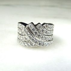 "This is a vintage 14K white gold ladies Cubic Zirconia cocktail band ring.  The ring is sized at a 7 and is 1/2\" wide.  There are 54 round cz stones that are 1.9mm each.  The total carat weight is 1.62 carats.  Total weight of the ring is 10.2 grams. This is a vintage, previously owned ring.  Therefore, light wear can be expected.  There is no visible damage." Classic White Diamond Ring With Wide Band, White Diamond Ring With Wide Band For Formal Events, White Diamond Ring With Wide Band For Formal Occasions, Classic White Wide Band Diamond Ring, Formal White Diamond Ring With Wide Band, Classic Wide Band Diamond Ring With Vvs Clarity, Elegant Wide Band Ring With Channel Set, Elegant White Gold Wide Band Ring For Anniversary, Elegant Wide Band Channel Set Ring