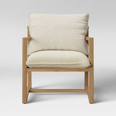 a wooden chair with a white cushion on it