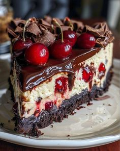 a piece of cake with chocolate and cherries on top