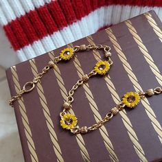 Sweet Sunny Bracelet. A classic to layer your way. 1990's Faux topaz stones, framed within yellow daisy petals. Delicate golden chain accented in fluted beads. Appears to be magnetic. Gleaming gold tone metal. (Not karat gold). This is a small size at 7.5 inches. Lobster clasp. Gift boxed. VINTAGE Vintage Adjustable Chain Jewelry, Adjustable Vintage Chain Jewelry, Adjustable Vintage Style Chain Jewelry, Retro Metal Jewelry For Gifts, Retro Metal Jewelry For Gift, Retro Jewelry With Adjustable Chain, Retro Gold Jewelry With Adjustable Chain, Retro Gold Jewelry For Gifts, Retro Necklace With 17 Jewels For Gift