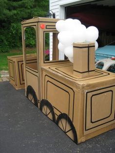 a cardboard train with balloons attached to it