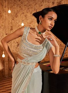 Elevate your style with this aqua drape sari, showcasing intricate embroidery on the sari border. The fully embroidered blouse steals the spotlight, and the outfit is both padded and secured with a hook-eye closure on the back, ensuring a perfect fit. Embrace the grace and charm of this ensemble, where every detail is thoughtfully crafted for a timeless appeal. Drape Sari, Embroided Blouse, Vacuum Storage, Drape Saree, Blouse Silk, Ready To Wear Saree, Indian Wedding Wear, Embroidered Border, Blue Saree