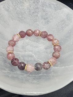 Add some sweet style to your wrist with our Strawberry Quartz Stretch Bracelet! This beautiful gemstone boasts stunning shades of pink and red, bringing positive energy and love into your life. A must-have for any crystal lover! Rose Quartz Crystal Bracelet With Natural Stones, Pink Crystal Bracelet With Stones As Gift, Round Rose Quartz Crystal Bracelet With Natural Stones, Pink Crystal Bracelet With Natural Round Beads, Pink Crystal Bracelet With Natural Stones, Pink Crystal Bracelet With Round Natural Stones, Pink Gemstone Crystal Bracelet, Pink Crystal Gemstone Bracelet, Pink Round Crystal Gemstone Bracelet