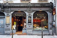 an old building with many windows and signs on the front