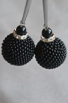 These feminine and delicate earrings are made with wood balls, beads, and silver plated rectangular ear studs. These earrings will give a special touch to your outfit! For everyday use or for a special occasion. The wood balls are covered by crocheted beads, handmade by me. Each pair of earrings is unique and exclusive, I only make one pair. The earrings measurements are Length: 2,55 inch; Width: 0,78 inch. Total Lenght: approx. 6,5 cm Total Weight: approx. 6 grams Ball Diameter: approx. 20mm  M Black Beaded Earrings With Round Beads As Gift, Round Black Beaded Earrings For Gifts, Beaded Ball Earrings, Black Beaded Round Earrings, Adjustable Round Black Beaded Earrings, Crystal Ball Earrings, Lilac Earrings, Present For Girlfriend, Letter Earrings