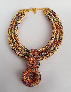 This necklace is 100% handcrafted using multi color beads. Perfect for African themed events. Measurements; 20 inches 18 inches(middle strand) 16 inches. 4 inch pendant. More neckleces here; https://www.etsy.com/shop/TribalTess?ref=seller-platform-mcnav&section_id=21306083 Back to my shop; https://www.etsy.com/shop/TribalTess?ref=seller-platform-mcnav Double Strand Polished Bead Necklaces, Double Strand Polished Beads Necklace, Multicolor Double Strand Beaded Necklace With Large Beads, Multicolor Double Strand Necklace With Large Beads, Multicolor Double Strand Beaded Necklaces, Multicolor Small Beads Multi-strand Jewelry, Multicolor Double Strand Jewelry With Tiny Beads, Multicolor Beaded Necklace With Pendant, Unique Multi-strand Colorful Beaded Necklaces