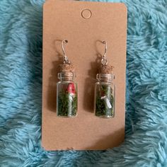 two tiny glass bottles with plants inside them