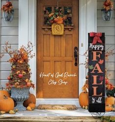 a front porch decorated for fall with pumpkins and decorations on the steps, and a happy fall sign