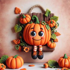 an orange pumpkin sitting on top of a wooden shelf next to other small pumpkins