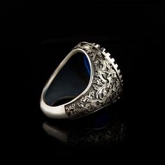 Blue Aqeeq Silver Men Ring. Handmade in 925 sterling silver with agate stone. On the ring Oval blue agate - aqeeq stone settled. Sides has special ornament by hand engraving technique. Dimensions of stone is 18 mm x 14 mm. Average weight of Blue Aqeeq Silver Men Ring is 15 gr. (depends your ring size). Back side is open to touch your skin. Classic and exclusive style. Stone Type: Agate - Aqeeq Stone Color: Blue Stone Dimensions: 18 mm x 14 mm Stone Shape: Oval Average Weight: 15 gr. Made in Ista Men Ring Silver, Silver For Men, Silver Handmade Jewelry, Silver Men Ring, Men Ring, Average Weight, Blue Band, Ring Oval, Blue Agate