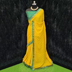 Product Detail - yellow colored casual wear saree is made from moss georgette fabric which is highlighted with beautiful stripes printed work with lace border as shown. Comes along unstitched heavy gota blouse piece which you can customise as per your design/style. Occasion - You can wear this saree for casual, outings, social meets and other homely events. Style it up - Look glamorous in this traditional saree by (HELUM FAB) Pair this saree with beautiful clutch to complete the look!! Measureme Yellow Georgette Pre-draped Saree With Pallu, Yellow Cutdana Blouse Piece For Navratri, Yellow Unstitched Blouse Piece With Traditional Drape, Green Georgette Dupatta With Printed Border, Yellow Bollywood Style Pre-draped Saree In Georgette, Yellow Bollywood Pre-draped Georgette Saree, Yellow Semi-stitched Pre-draped Saree, Semi-stitched Yellow Pre-draped Saree, Yellow Georgette Pre-draped Saree For Festivals