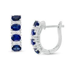 These fashion-forward gemstone and diamond hoop earrings are a jewelry box must-have. Crafted in 14K white gold, each earring features four 5.0 x 3.0mm oval-shaped bright blue sapphires alternating with duos of glistening diamonds. Captivating with 1/4 ct. t.w. diamond and a brilliant buffed luster, these earrings secure with hinged backs. Fine Jewelry Gemstone Hoop Earrings For Formal Occasions, Fine Jewelry Hoop Earrings With Gemstones For Formal Events, Classic Oval Sapphire Diamond Earrings, Sapphire Color Oval Diamond Earrings, Sapphire Oval Diamond Earrings, Formal Oval Diamond Earrings With Gemstones, Elegant Gemstone Hoop Earrings For Formal Occasions, Formal Sapphire Diamond Oval Earrings, Formal Oval Sapphire Diamond Earrings