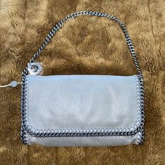 Falabella Clutch Bag By Stella Mccartney Brand New With Tags Gray Faux Vegan Leather Suede (Stella Mccartney Never Uses Real Animal Leather) Silver Hardware Chain Trims Chain Shoulder Strap (Convertible - Just Hide The Strap) Magnetic Snap-Fastening Front Flap Internal Pocket Fully Lined In Jacquard 100% Authentic Purchased On The Outnet But Never Used As I Have Many Other Stella Bags Luxury Silver Bags With Chain Strap, Luxury Silver Bag With Chain Strap, Luxury Silver Crossbody Shoulder Bag, Luxury Silver Shoulder Bag With Chain Strap, Silver Shoulder Bag With Top Handle And Chain Strap, Silver Evening Shoulder Bag, Luxury Silver Clutch Shoulder Bag, Silver Luxury Clutch Shoulder Bag, Silver Leather Clutch Shoulder Bag