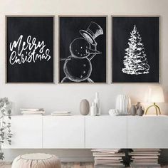 two black and white christmas paintings on the wall