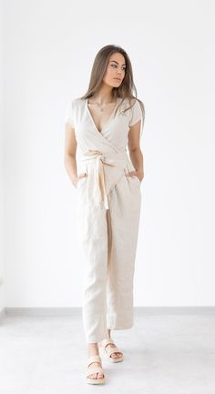 Wrap linen jumpsuit Mila  - relaxed fit linen soft linen jumpsuit / beach jumpsuit. Summer clothing created by MinimalisticLinen DETAILS ----------------- * short sleeves * Wrap jumpsuit * Pockets * Belt * Made from OEKO - TEX Standard 100 certified European linen fabric which guarantees you that it meets human - ecological requirements. * Handmade item. Cut and sewn by professionals in our family studio.  FIT ----------------- * Relaxed fit IMAGES ----------------- * Model is wearing XS/S * Please note that colors can slightly mismatch from pictures due to factors that are beyond our control like your display settings, device you are using etc. CARE INSTRUCTIONS ----------------- * Machine wash in cold water up to 30ºC/86ºF gentle cycle * Dry on low heat or hang to dry for best results. * Beige Linen Casual Jumpsuits And Rompers, Chic Linen Jumpsuits And Rompers With Short Sleeves, Chic Linen Jumpsuits And Rompers With Tie Waist, Linen V-neck Jumpsuits And Rompers For Spring, Spring Linen V-neck Jumpsuit, Spring Linen Jumpsuit With V-neck, Beige Linen Jumpsuits And Rompers For Loungewear, Beige Linen Overall Jumpsuits And Rompers, Beige Linen Overalls Jumpsuit