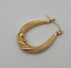 Single 14K Oval Hoop Tube with Twist Yellow Gold Post Earring Vintage Karat KT Solid Pierced (only 1 earring) Materials: 14K solid gold metal marked - 585 = 14K Condition: very good vintage & are hollow - with one ding that I see (in last image close-up) Weight in grams - .69 Measures - 1 x 3/4 x  1/8 inches Maker's mark - ZZ with a mark but I cannot make it out Questions welcome. Oval Yellow Gold Hoop Earrings Stamped 14k, Oval 14k Stamped Yellow Gold Hoop Earrings, Gold Oval Earrings Stamped 14k, Classic Gold Plated Oval Hoop Earrings, Classic Oval Gold-plated Hoop Earrings, Classic Oval Gold Plated Hoop Earrings, Oval 14k Gold Tarnish-resistant Hoop Earrings, Oval 14k Gold Tarnish Resistant Hoop Earrings, 14k Gold Oval Hoop Earrings Tarnish Resistant