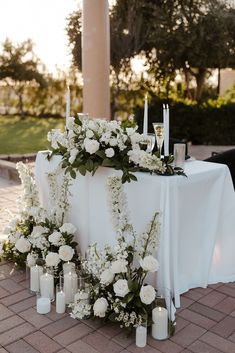 a table with candles and flowers on it