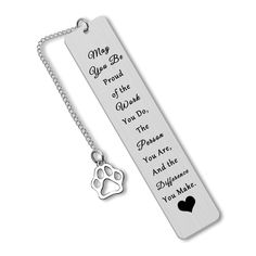 a bookmark with a dog's paw on it and a heart charm hanging from the front