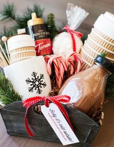 a basket filled with hot chocolates, marshmallows and candy canes