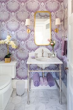 the bathroom is decorated in purple and white