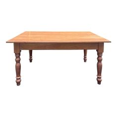 a wooden table with two turned legs and a wood top on an isolated white background