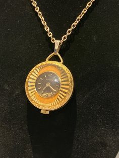 My mom has had this in her jewelry box since the 1970s. The hands do not move unless you manipulate the crank, its operational capacity is unknown.  A 24 inch gold tone chain holds a gold tone Swiss made Lucerne watch pendant. the chain is original and has not been polished, you can swap it out for a black satin cord, just leave a message. sorry, longer chains are not available.  Sold as is, I will not alter it or try to get it working for authenticity's sake. It is a beautiful piece, of a rarer Antique Gold Round Jewelry And Watches, Collectible Engraved Gold Jewelry And Watches, Engraved Gold Jewelry And Watches For Collectors, Retro Gold Medallion Jewelry, Gold Collectible Pocket Watch, Gold Pocket Watch Collectible, Gold Pocket Watch For Collectors, Retro Gold Round Pendant Jewelry, Timeless Gold Metal Pocket Watch