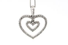 Share your loving wishes with her in the form of this diamond double-heart pendant. Crafted in cool 14K white gold, this two-heart dangle is lined with shimmering diamonds and suspends from a diamond-adorned linear bail. Mons scale diamond 10 / Color - G/H ,Clarity - SI weigh Diamond .31 ctw Total weight pendant and chain 2.34 g pendant size 3/4 inch, chain 18 inch will ship in jewelry box ready for gift. free shipping over night US payers . If you international custom please contact to me . Valentine's Day White Diamond Heart Pendant Necklace, Diamond White Jewelry With Diamond Accents Heart Pendant, Valentine's Day Heart Pendant Diamond Cut Jewelry, Heart-shaped Diamond Necklace For Valentine's Day, Double Heart Necklace, Heart-shaped Diamond Accented Pendant Necklace For Valentine's Day, Valentine Day Gift, Wedding Christmas, Necklace Wedding