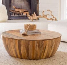 a living room with a fire place and a coffee table in the middle of it