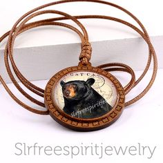 "BOHEMIAN STYLE JEWELRY Brown Bear Spirit Animal Necklace\" Photo glass cabochon jewelry Is the brown bear your spirit animal or do you need the wisdom the brown bear gives us? If so this pendant might be just for you. This pendant has a 30 mm photo glass dome cabochon. It is set in a wooden circle pendant and attached to a natural leather cord that adjust easily from 18 inch to 35 inches making it very versatile. The natural elements of this new pendant design uses glass, leather, wood and pape Brown Spiritual Personalized Jewelry, Adjustable Brown Jewelry For Collectors, Vintage Brown Jewelry Gift, Nature-inspired Brown Jewelry, Nickel-free Brown Jewelry For Gifts, Nature-inspired Brown Round Jewelry, Nickel-free Brown Necklace For Gift, Brown Amulet Style Round Pendant Necklace, Nature-inspired Brown Round Pendant Jewelry