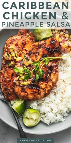 a white plate topped with chicken and rice next to cucumber on the side