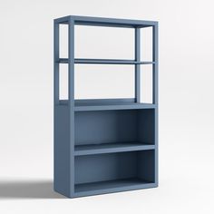 a blue bookcase with three shelves on the bottom and one shelf below it, in front of a white background