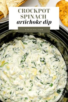 crockpot spinach artichoke dip in a slow cooker with tortilla chips on the side