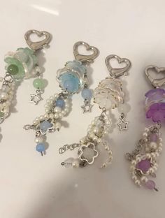 several charms are sitting on a table next to each other and one has a heart