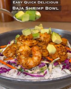 a bowl filled with shrimp and vegetables on top of rice next to a spoon full of avocado