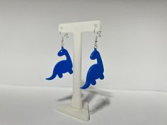 3D printed dinosaur earrings with silver plated backings. Stylish and Sustainable: Biodegradable Earrings Because these are 3D Printed they can display layer lines, which is part of the printing process. If you have questions, please feel free to contact me! Earrings 3d Print, Biodegradable Earrings, 3d Printer Art, 3d Earrings, 3d Printed Earrings, Printed Earrings, Disney Earrings, 3d Printing Art, Dinosaur Earrings