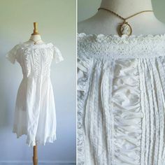 This dreamy antique nightgown features white cotton with an eyelet, embroidered lace neckline; a feminine bodice striped with columns of pintuck pleating and ruching; banded, lacy sleeves; a flowing skirt; and a pintuck-pleated ruffle hem. Absolutely darling and evocative of the era. May easily be worn as nightwear or as a dress. It is on excellent condition, the sturdy cotton is structurally sound and very wearable. About knee length, fits up to US medium sizes. Era: Victorian/Edwardian, turn o Daywear Prairie Dress With Lace Trim, Cottagecore Victorian Dress For Daywear, Cottagecore Victorian Dress With Lace Trim In Vintage White, Vintage White Victorian Dress With Lace Trim For Daywear, Cottagecore Prairie Dress With Lace Trim For Daywear, Daywear Victorian Dress With Lace Patchwork, Victorian Prairie Dress With Lace Trim In White, Summer Daywear Victorian Dress With Lace Trim, White Victorian Dress With Lace Patchwork For Daywear