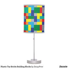 a lamp made out of lego blocks on a metal stand with a white base and light shade