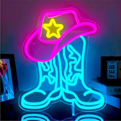 a neon sign with a cowboy hat and boots on it's side in the dark