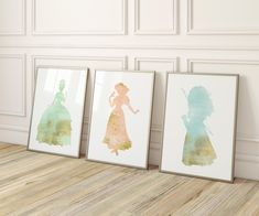 three disney princess silhouettes are displayed on the wall