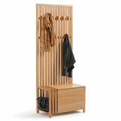 a wooden coat rack with two coats hanging on it's sides and a black bag next to it