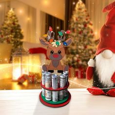 a santa hat and reindeer figurine sitting next to cans of christmas cheerios