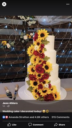 the wedding cake is decorated with sunflowers and red carnations on it