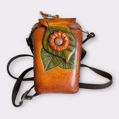 New With Tag. Genuine Leather Crossbody Bag. Orange Flower On Top Of Large Green Leaves. Large Enough To Carry Your Cell Phone, Your Credit/Debit Cards, Or Makeup. It Can Be Used Either As A Cross Shoulder Bag For Both Women Or A Wristlet. 6.5" High X 4.5" Wide. Nice Quality Leather. Great For Handsfree Errand Running. Enjoy! Brown Crossbody Mobile Phone Bag, Yellow Pouch Phone Bag For Daily Use, Brown Handheld Phone Bag With Adjustable Strap, Handheld Brown Phone Bag With Adjustable Strap, Brown Handheld Phone Bag, Portable Yellow Phone Bag For Everyday Use, Vintage Crossbody Phone Bag For Daily Use, Vintage Phone Bag With Cell Phone Pocket, Orange Rectangular Pouch With Removable Section