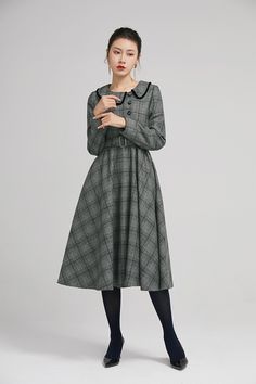 "Simple. With its pleated skirt and grayscale plaid pattern, this vintage wool dress epitomizes classic styling. She's all class and quality with no bells or whistles. Near-perfect vintage condition, designed with lapel collar, long sleeves and tie belt waist, it will be your favorite one of your wardrobe. Details: * 35% wool blend, 35% fiber and polyester, 30% nylon * Polyester lining * long sleeves * tie belt waist * lapel collar * button decoration in front * knee length * back zipper closure Classic Long Sleeve Tweed Dress For Winter, Vintage Plaid Winter Dress, Vintage Plaid Dress For Winter, Classic Vintage Dress For Work In Fall, Classic Vintage Dress For Fall Workwear, Vintage Plaid Dress For Fall, Classic Fall Vintage Dress For Workwear, Elegant Winter Plaid Dress, Retro Plaid Winter Dresses