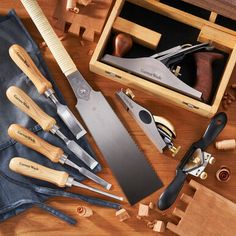 a wooden box filled with different types of kitchen utensils and other woodworking tools