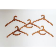 four wooden clothes hangers on a white background