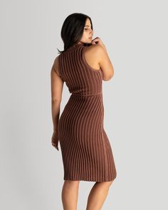 If you are looking for a versatile addition to your wardrobe, this is the piece! Knit using Pima cotton in Peru, this dress is super soft and easy to wear. Whether paired with sneakers for a casual weekend look, or dressed up with heels for a night out, this dress is sure to turn heads. The two tone Maroon and Toffee yarn has a monochrome effect that highlights the beauty of the yarn and rib stitch. The cord at the waist can be adjusted to accommodate the desired comfort and fit. Chic Brown Knit Dress, Brown Ribbed Knee-length Midi Dress, Fitted Knee-length Sweater Dress For Loungewear, Brown Knit Dresses For Spring, Stretch Knit Dress For Loungewear, Stretch Knit Lounge Dresses, Brown Ribbed Knit Dress, Brown Knee-length Knit Dress, Fitted Brown Knit Sweater Dress