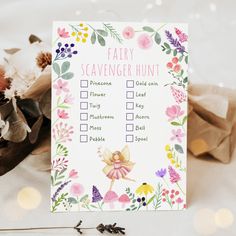 a fairy scavenger hunt is shown on a table next to flowers and leaves